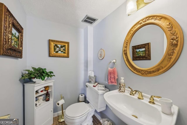 1487 W Bend Creek Ct, Atlanta, GA 30338 - bathroom with toilet, a sink, tile patterned floors, a textured ceiling, and baseboards