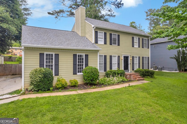 557 Spring Creek Way NE, Marietta, GA 30068 - colonial house with a chimney, a shingled roof, and central air condition unit