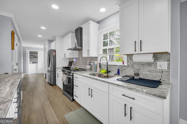 557 Spring Creek Way NE, Marietta, GA 30068 - kitchen with stainless steel appliances, a sink, wall chimney exhaust hood, separate washer and dryer, and white cabinets