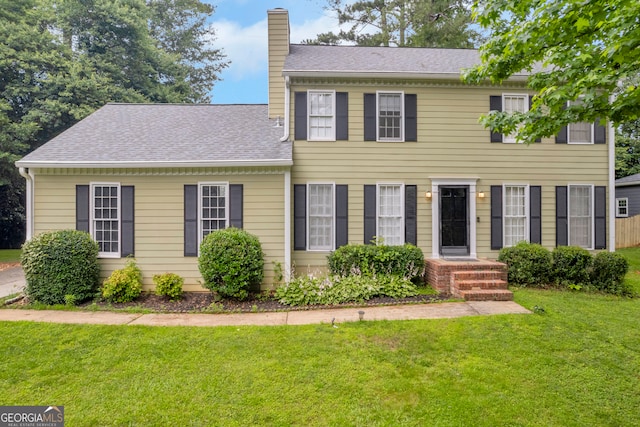 557 Spring Creek Way NE, Marietta, GA 30068 - view of front of property featuring a chimney, a front lawn, and roof with shingles