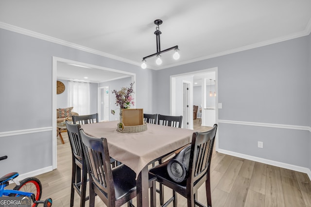 557 Spring Creek Way NE, Marietta, GA 30068 - dining room with light wood-type flooring, crown molding, and baseboards