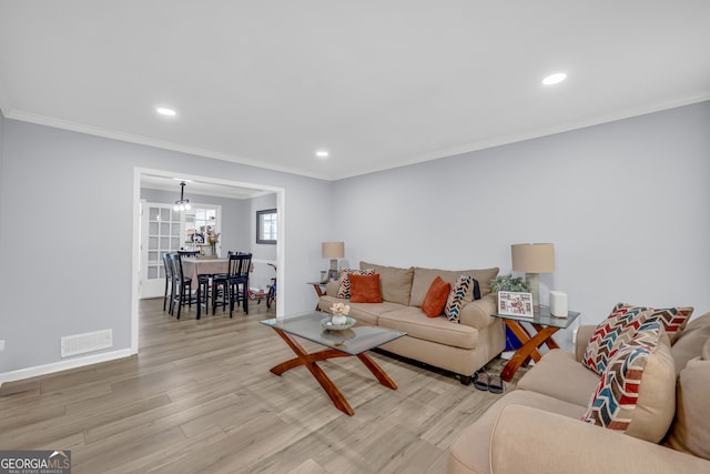 557 Spring Creek Way NE, Marietta, GA 30068 - living room featuring wood finished floors, crown molding, recessed lighting, baseboards, and a chandelier