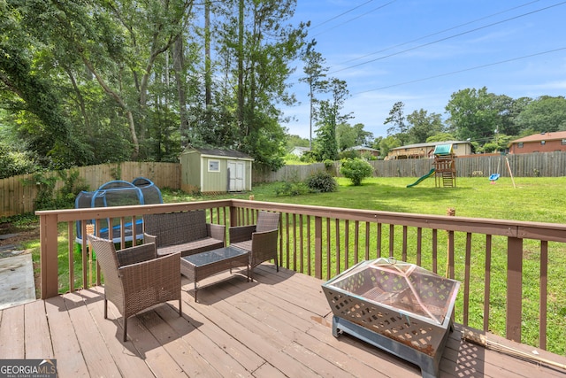 557 Spring Creek Way NE, Marietta, GA 30068 - wooden terrace with a playground and an outdoor living space with a fire pit