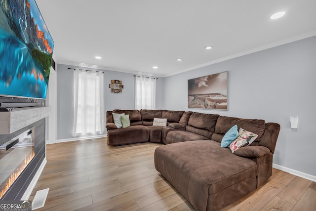 557 Spring Creek Way NE, Marietta, GA 30068 - living area featuring ornamental molding, baseboards, a glass covered fireplace, hardwood / wood-style flooring, and recessed lighting