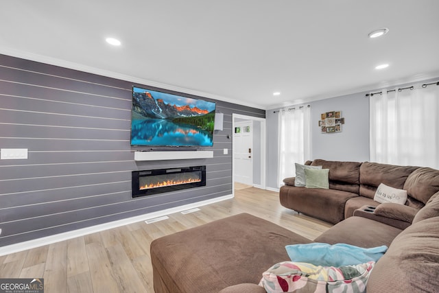 557 Spring Creek Way NE, Marietta, GA 30068 - living room with a glass covered fireplace, crown molding, wood finished floors, recessed lighting, and baseboards