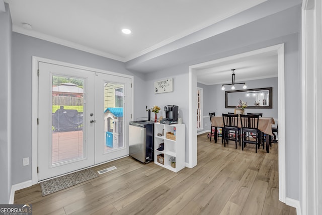 557 Spring Creek Way NE, Marietta, GA 30068 - entryway with french doors, ornamental molding, light wood finished floors, baseboards, and recessed lighting