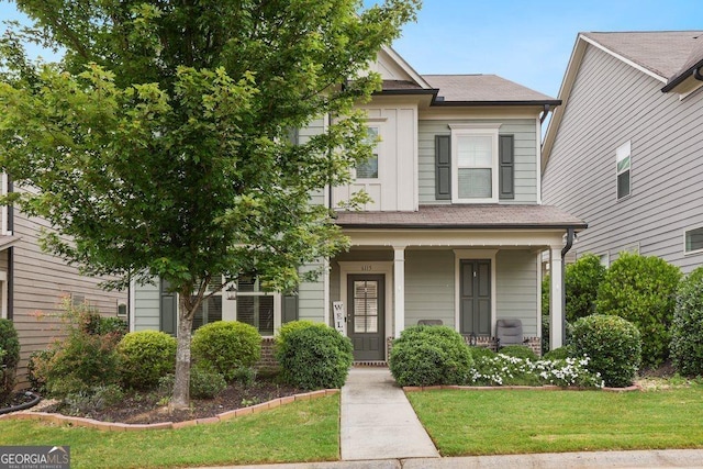 6115 Stella Light Dr, Flowery Branch, GA 30542 - view of front facade featuring a porch, a front lawn, and a shingled roof