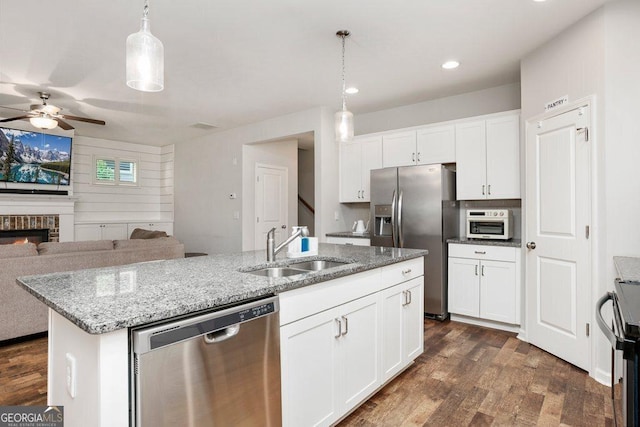 6115 Stella Light Dr, Flowery Branch, GA 30542 - kitchen featuring appliances with stainless steel finishes, a sink, a ceiling fan, open floor plan, and a kitchen island with sink