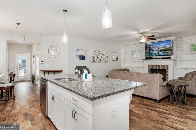 6115 Stella Light Dr, Flowery Branch, GA 30542 - kitchen with a sink, dishwasher, dark wood finished floors, ceiling fan, and light stone countertops
