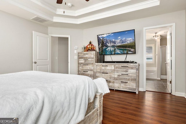 6115 Stella Light Dr, Flowery Branch, GA 30542 - bedroom with crown molding, dark wood-type flooring, a tray ceiling, a ceiling fan, and connected bathroom