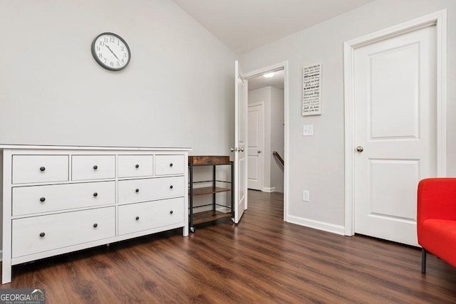 6115 Stella Light Dr, Flowery Branch, GA 30542 - living area with dark wood-type flooring, baseboards, and vaulted ceiling