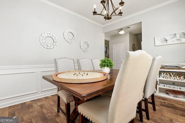 6115 Stella Light Dr, Flowery Branch, GA 30542 - dining area with a chandelier, crown molding, dark wood finished floors, wainscoting, and a decorative wall