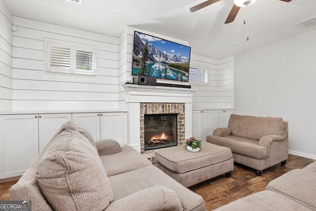 6115 Stella Light Dr, Flowery Branch, GA 30542 - living area featuring a ceiling fan, wood finished floors, a fireplace, and wooden walls
