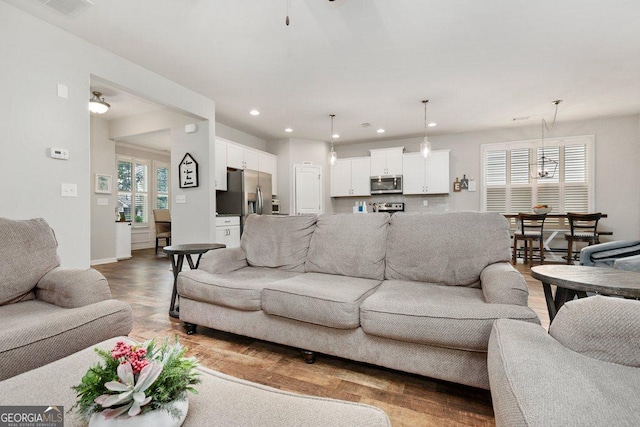 6115 Stella Light Dr, Flowery Branch, GA 30542 - living room featuring recessed lighting, plenty of natural light, light wood-style flooring, and baseboards