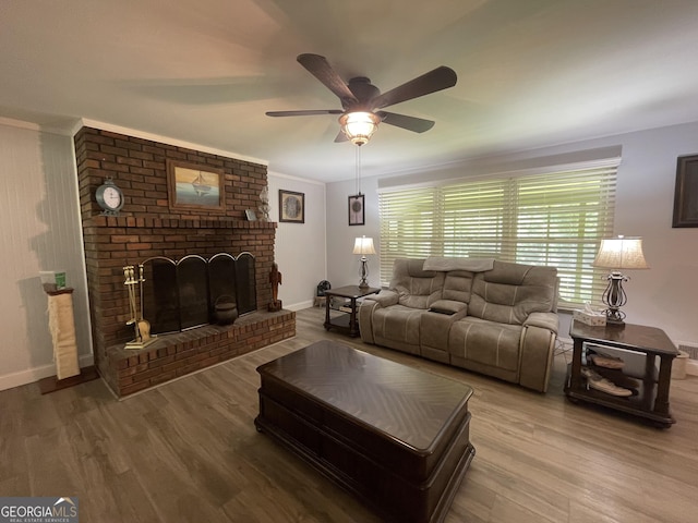 424 Harkins Rd, Cleveland, GA 30528 - living area featuring wood finished floors, a ceiling fan, a brick fireplace, baseboards, and crown molding