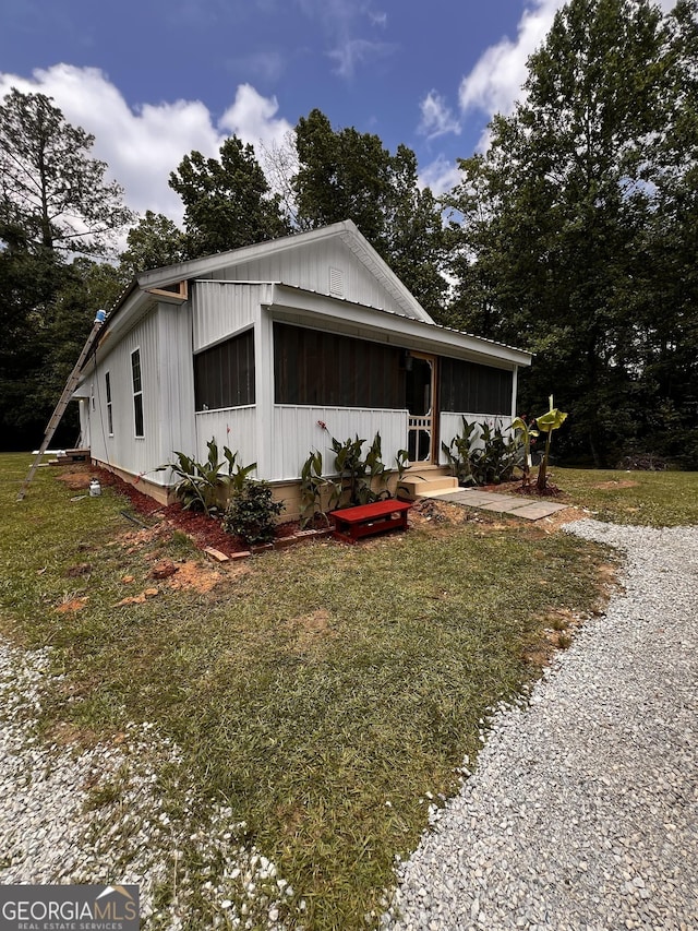 44 Freeman, Heflin, AL 36264 - view of front of home featuring a front yard and board and batten siding