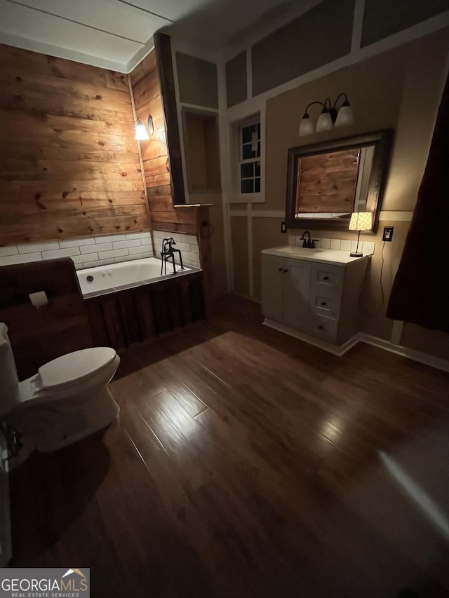 44 Freeman, Heflin, AL 36264 - bathroom with vanity, a garden tub, wood finished floors, and wood walls