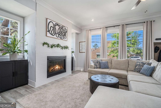 710 Elmwood Way, Roswell, GA 30075 - living area featuring ornamental molding, light wood finished floors, a fireplace with flush hearth, and a ceiling fan