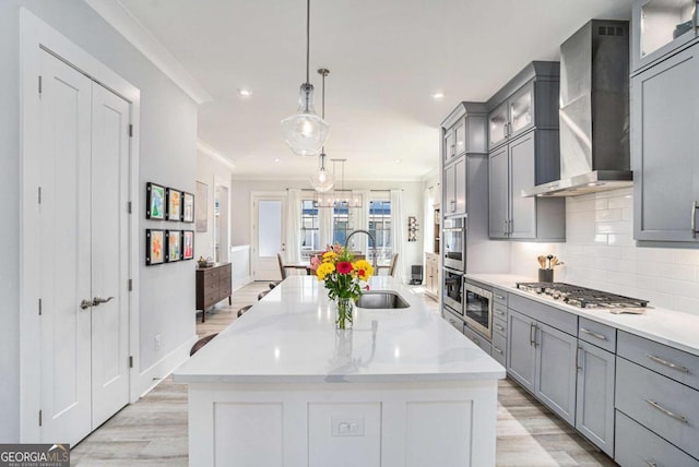 710 Elmwood Way, Roswell, GA 30075 - kitchen with wall chimney range hood, gray cabinetry, light wood-style floors, stainless steel appliances, and recessed lighting