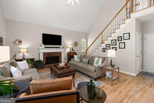 220 Webley Ln, Alpharetta, GA 30022 - living room featuring wood finished floors, stairs, high vaulted ceiling, ceiling fan, and a brick fireplace