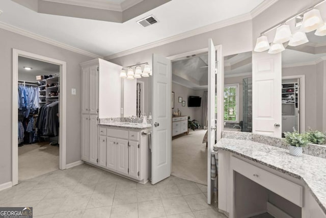 220 Webley Ln, Alpharetta, GA 30022 - full bath featuring vanity, crown molding, a walk in closet, baseboards, and tile patterned flooring