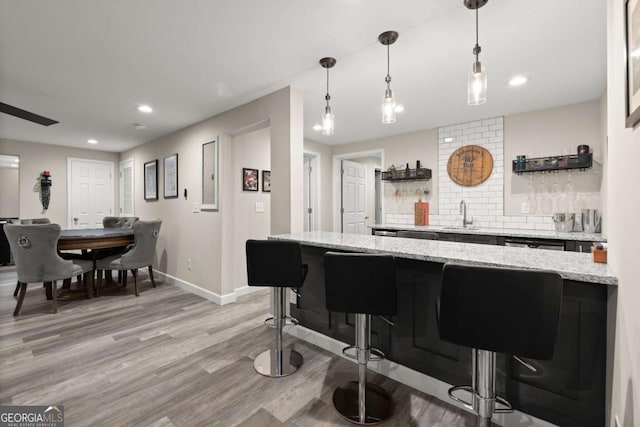 220 Webley Ln, Alpharetta, GA 30022 - kitchen featuring a sink, light wood-type flooring, baseboards, recessed lighting, and a kitchen breakfast bar