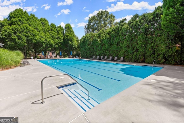 220 Webley Ln, Alpharetta, GA 30022 - community pool featuring a patio and view of scattered trees