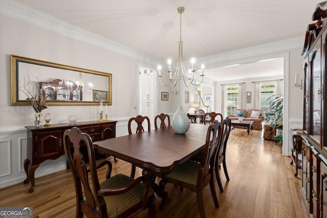 220 Webley Ln, Alpharetta, GA 30022 - dining space with a chandelier, light wood-style floors, wainscoting, ornamental molding, and a decorative wall