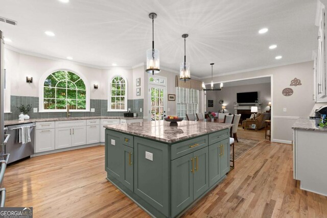 220 Webley Ln, Alpharetta, GA 30022 - kitchen with stainless steel dishwasher, green cabinetry, white cabinetry, decorative backsplash, and crown molding