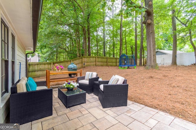 2038 Summertown Dr, Norcross, GA 30071 - fenced backyard featuring a patio, a trampoline, a grill, and an outdoor living space