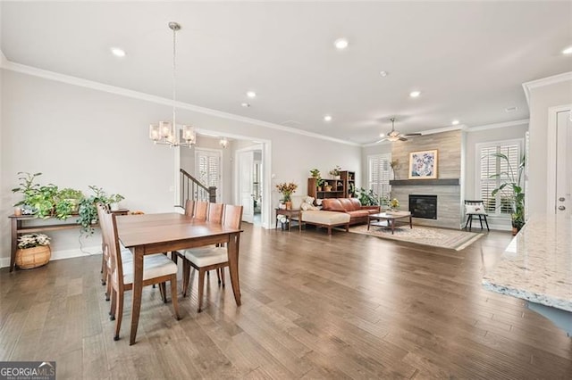 993 Harvest Park Ln, Suwanee, GA 30024 - dining area with a chandelier, ornamental molding, wood finished floors, a fireplace, and recessed lighting