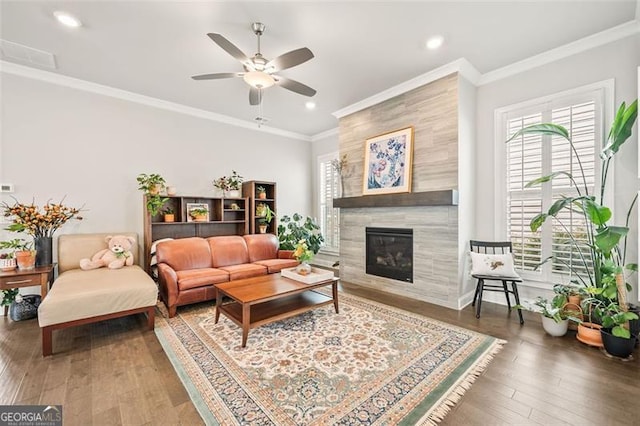 993 Harvest Park Ln, Suwanee, GA 30024 - living area with ceiling fan, a tiled fireplace, ornamental molding, wood finished floors, and recessed lighting