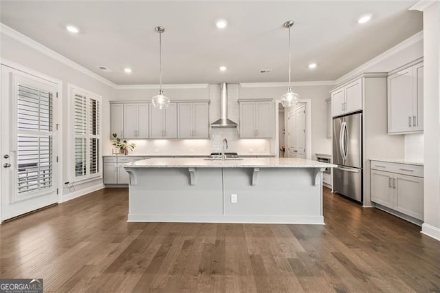 993 Harvest Park Ln, Suwanee, GA 30024 - kitchen with wall chimney exhaust hood, freestanding refrigerator, light stone countertops, dark wood finished floors, and ornamental molding