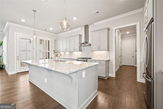 993 Harvest Park Ln, Suwanee, GA 30024 - kitchen featuring wall chimney range hood, crown molding, dark wood-type flooring, stainless steel refrigerator, and light stone countertops
