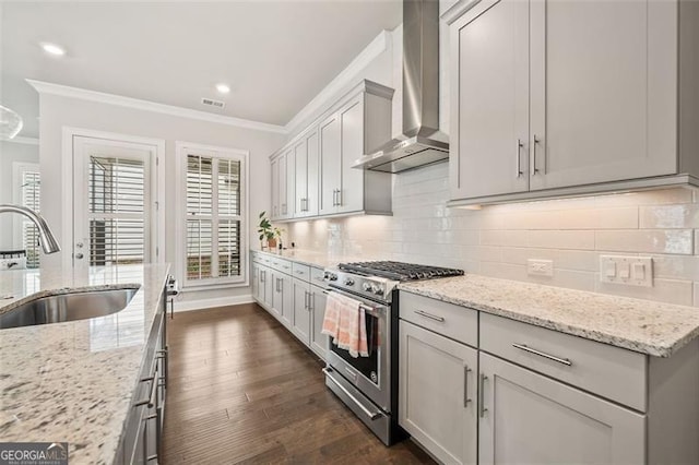 993 Harvest Park Ln, Suwanee, GA 30024 - kitchen featuring stainless steel gas range oven, wall chimney exhaust hood, ornamental molding, dark wood-style flooring, and backsplash