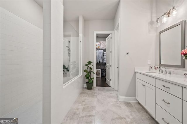 993 Harvest Park Ln, Suwanee, GA 30024 - bathroom with a walk in shower, vanity, and a spacious closet