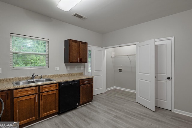 2137 Chadwick Rd SW, Atlanta, GA 30331 - kitchen with black dishwasher, a sink, light wood finished floors, light countertops, and baseboards