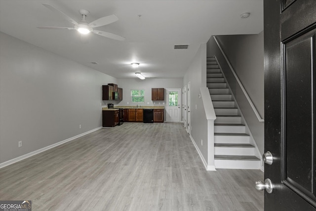 2137 Chadwick Rd SW, Atlanta, GA 30331 - unfurnished living room with light wood-type flooring, ceiling fan, stairway, and baseboards