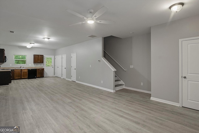 2137 Chadwick Rd SW, Atlanta, GA 30331 - unfurnished living room featuring a ceiling fan, light wood-style floors, stairway, and baseboards