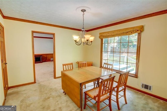 402 Princeton Way, Lawrenceville, GA 30044 - dining space featuring light carpet, a chandelier, and crown molding