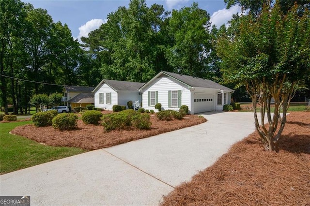 402 Princeton Way, Lawrenceville, GA 30044 - view of front of house featuring concrete driveway, a garage, and view of wooded area