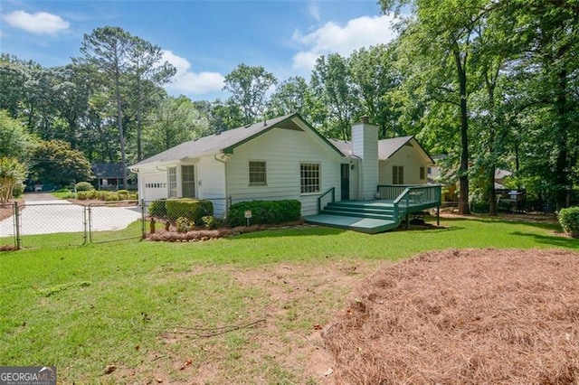 402 Princeton Way, Lawrenceville, GA 30044 - back of property featuring a wooden deck, an attached garage, and view of wooded area