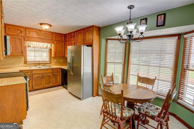 402 Princeton Way, Lawrenceville, GA 30044 - kitchen with stainless steel refrigerator with ice dispenser, white microwave, a chandelier, range, and light countertops