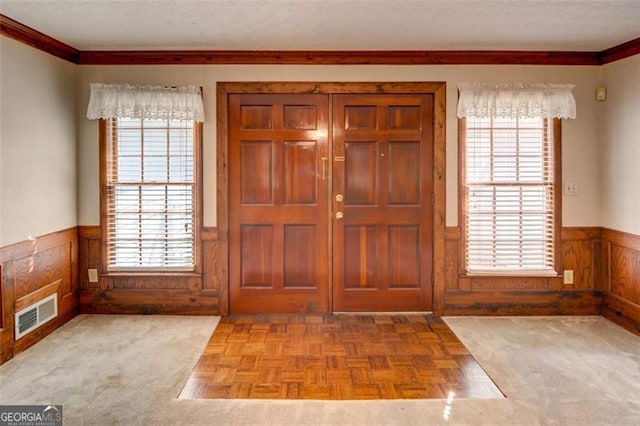 402 Princeton Way, Lawrenceville, GA 30044 - foyer featuring a wainscoted wall, crown molding, healthy amount of natural light, and a textured ceiling