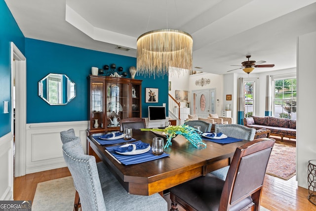 638 Glen Valley Way, Dacula, GA 30019 - dining space featuring wood finished floors, ceiling fan, and wainscoting