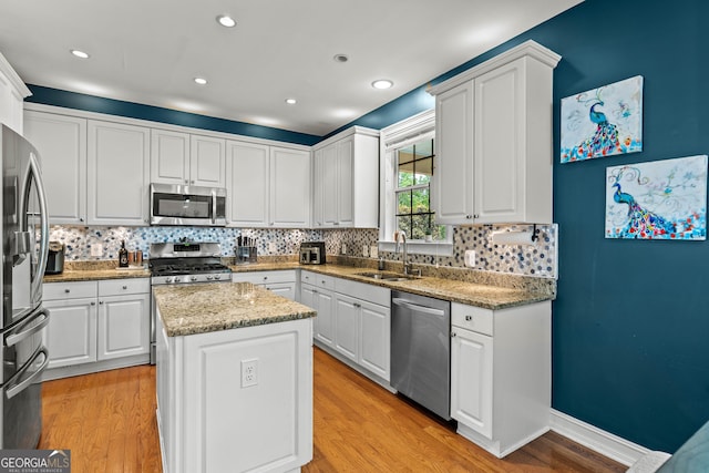 638 Glen Valley Way, Dacula, GA 30019 - kitchen featuring stainless steel appliances, backsplash, white cabinetry, a kitchen island, and recessed lighting