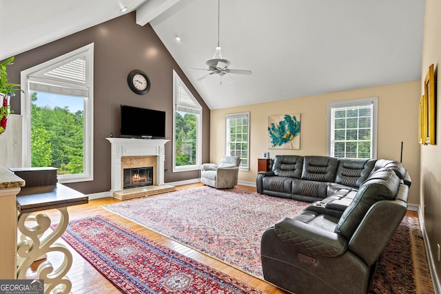 638 Glen Valley Way, Dacula, GA 30019 - living room featuring wood finished floors, beam ceiling, a ceiling fan, a high end fireplace, and high vaulted ceiling