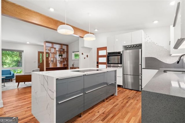 1492 Sagewood Cir, Stone Mountain, GA 30083 - kitchen with stainless steel appliances, modern cabinets, white cabinetry, gray cabinets, and light wood-type flooring
