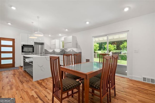 1492 Sagewood Cir, Stone Mountain, GA 30083 - dining area with light wood finished floors and recessed lighting