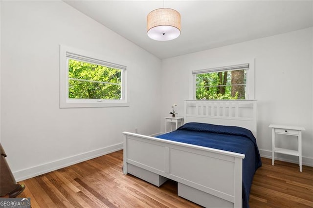 1492 Sagewood Cir, Stone Mountain, GA 30083 - bedroom with wood finished floors and lofted ceiling